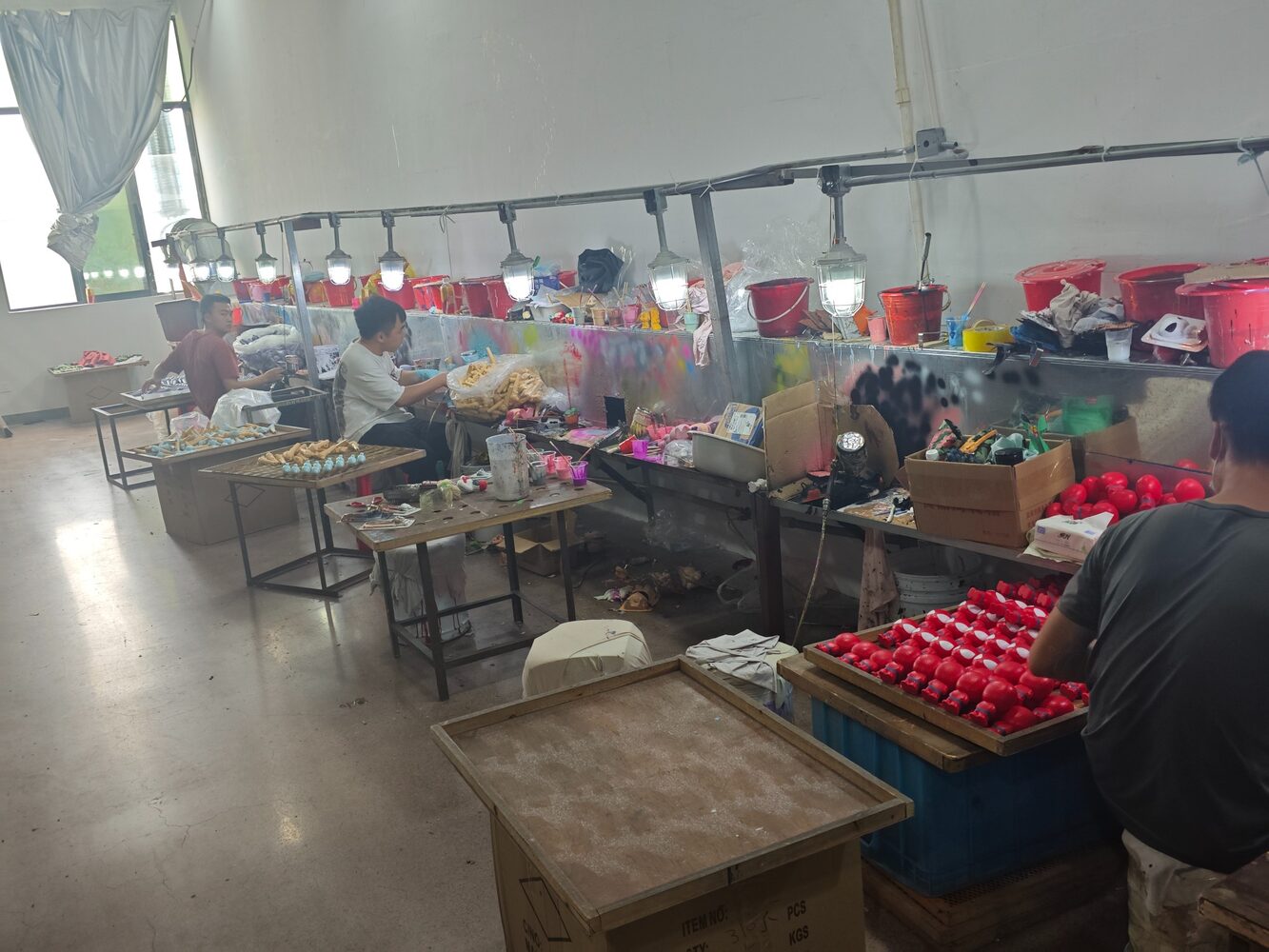 Workers finishing custom toys in the workshop